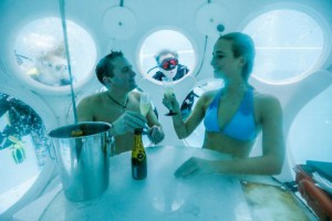 Belgians Florence Lutje Spelberg and Nicolas Mouchart drink champagne while sitting inside "The Pearl", a spheric dining room placed 5 metres underwater in the NEMO33 diving center, one of the world's deepest pools (33 metre/36 yards) built to train professional divers, before enjoying a meal inside, in Brussels, Belgium January 30, 2017. Picture taken January 30, 2017 REUTERS/Yves Herman